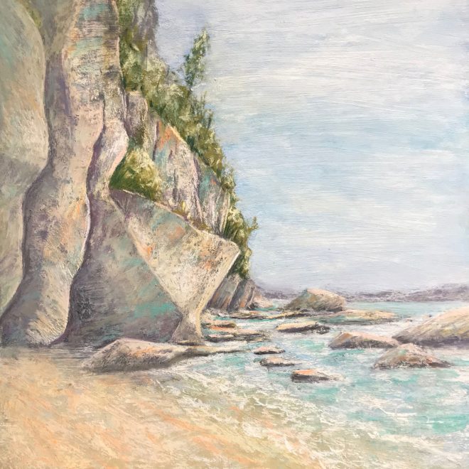 A rocky cliff lies at the breaker's edge (Lynn Norton)